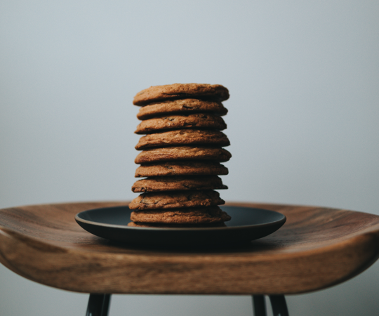 cookies stacked on a plate on a stool